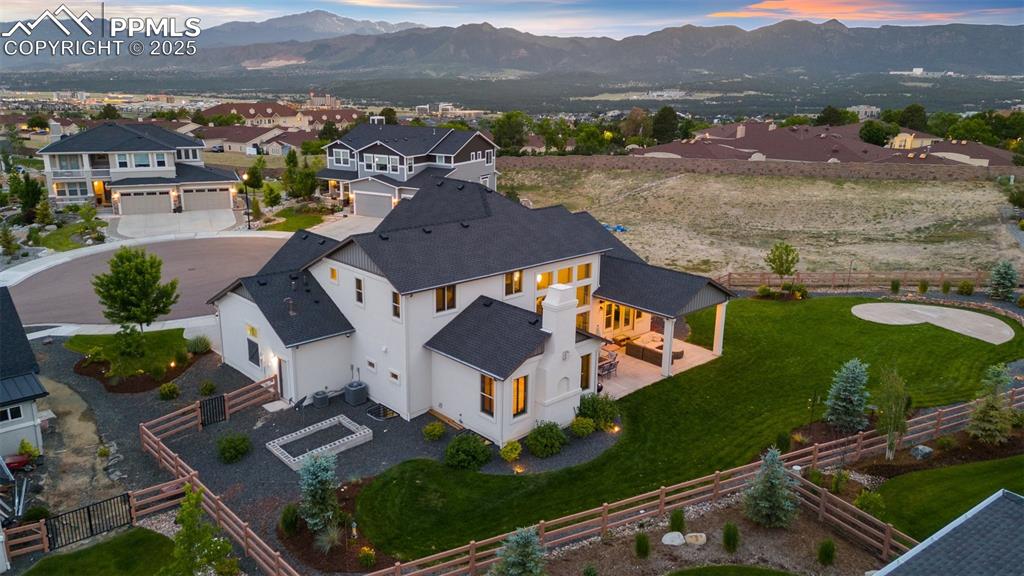Image 6 of 49: Spacious backyard with a covered patio and stunning mountain views