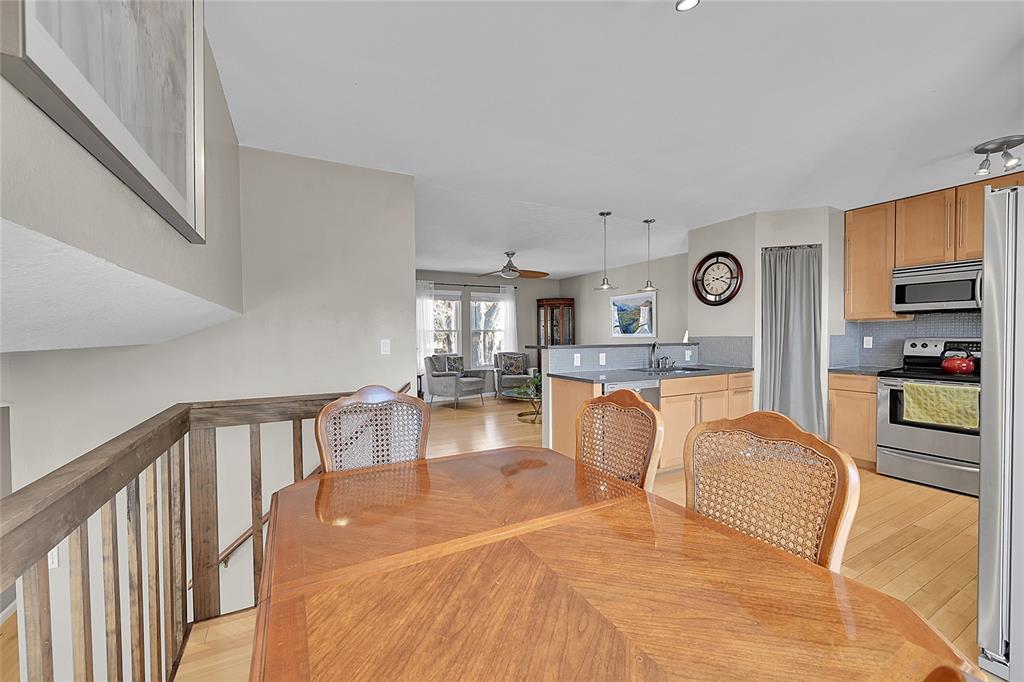 Image 12 of 45: Dining area featuring ceiling fan and light wood-style flooring