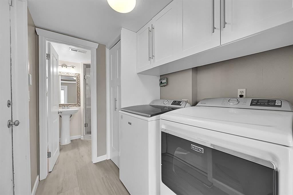 Image 16 of 45: Custom laundry with overhead cabinets!