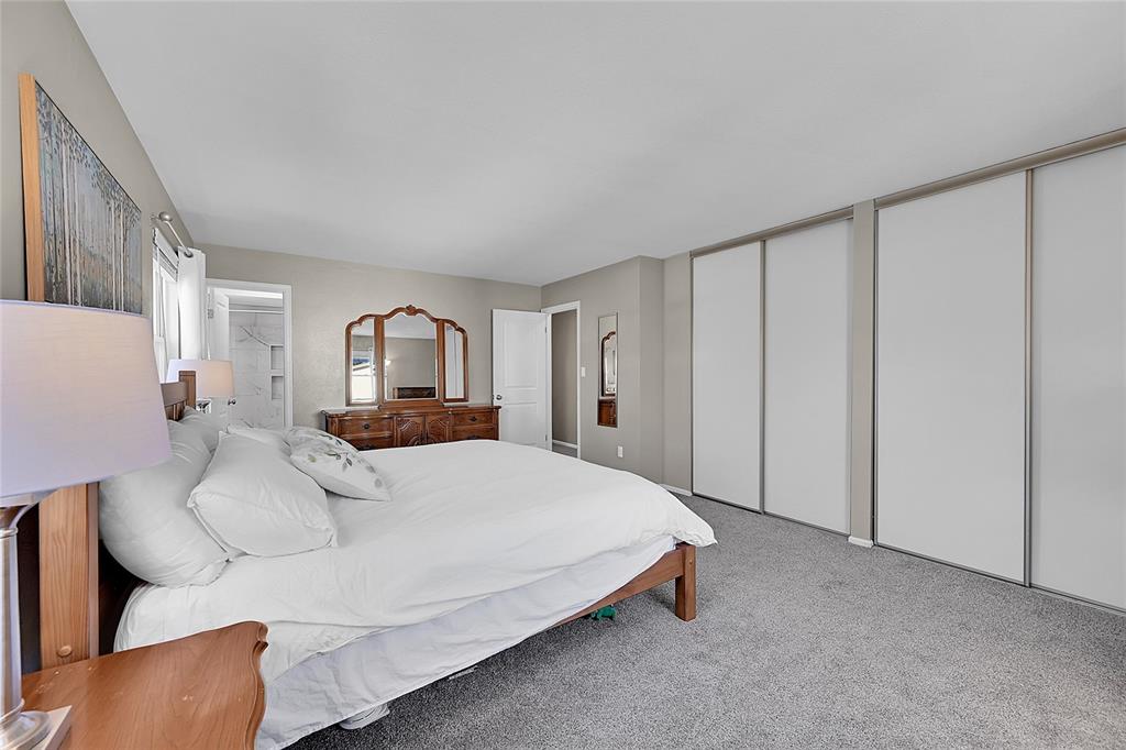 Image 19 of 45: Carpeted bedroom with two closets