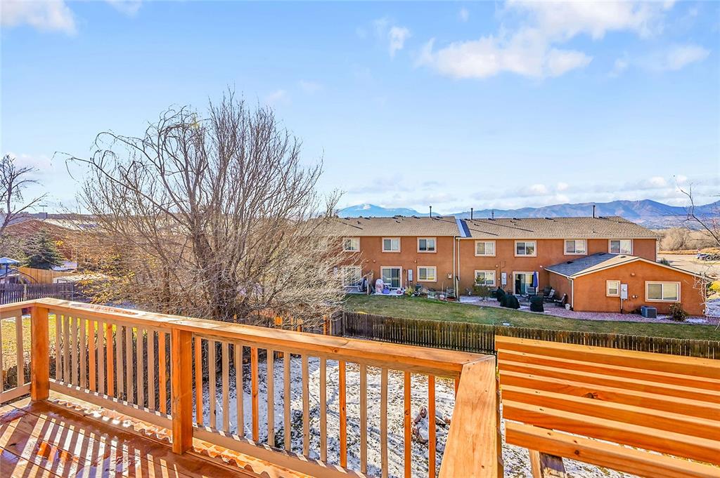 Image 29 of 45: Wooden deck with a fenced backyard, a residential view, and a mountain view