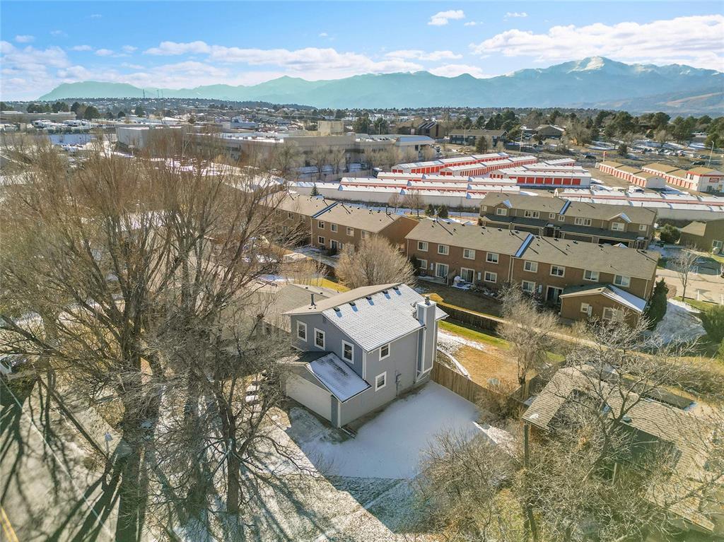 Image 39 of 45: Aerial view of residential area with a mountain backdrop