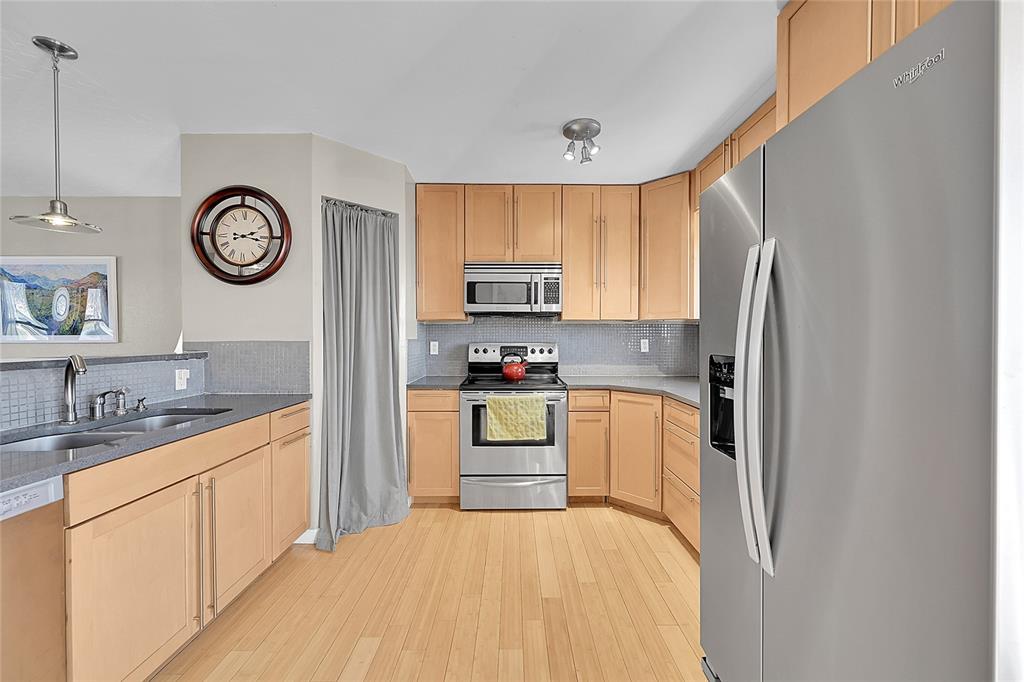 Image 9 of 45: The kitchen has decorative lighting, back splash and pantry!