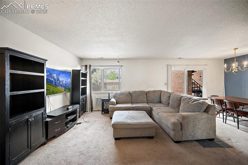 Image 7 of 25: Large window with walk out allows plenty of natural light flow into the hom