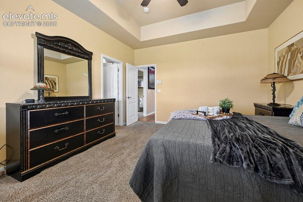 Image 18 of 39: Recessed ceiling with a ceiling fan, light beige wall color, and light-tone