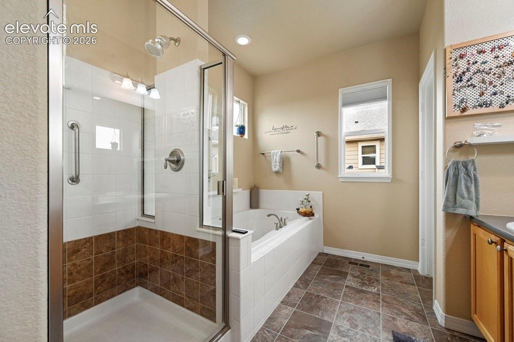 Image 21 of 39: Walk-in shower with clear glass enclosure and tile surround
