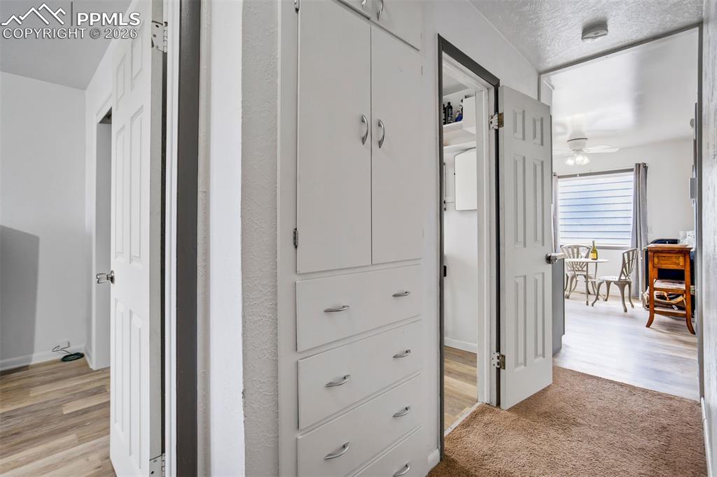 Image 19 of 37: Hallway features smartly placed cupboards and shelving.