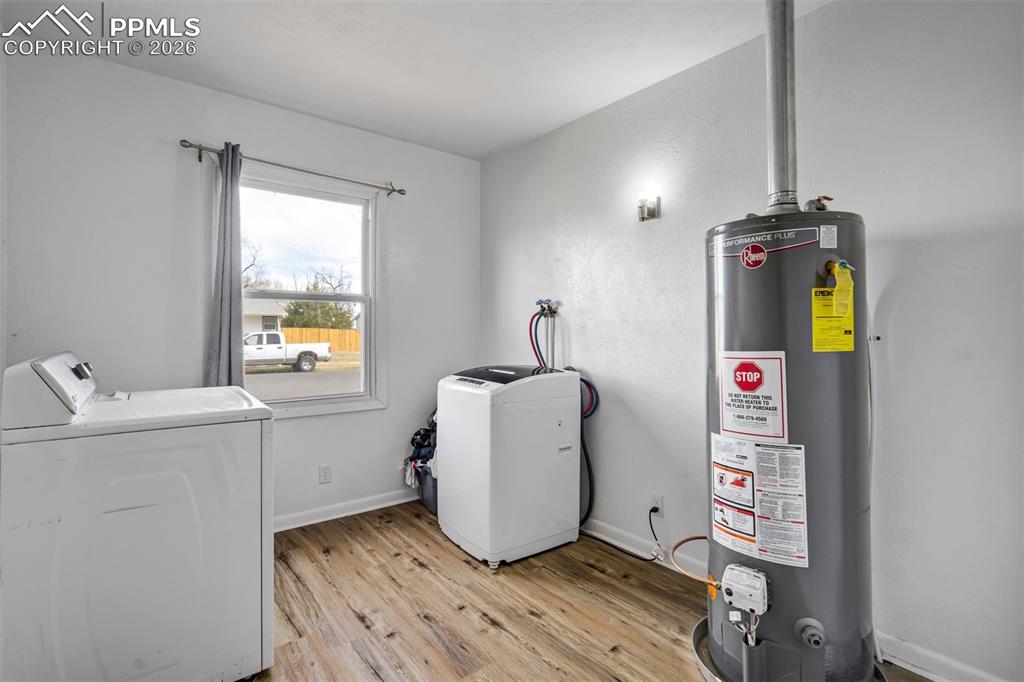 Image 23 of 37: Bright, roomy laundry with large window.