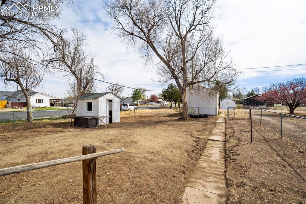 Image 25 of 37: Exterior view, pathway to alley and the shed.
