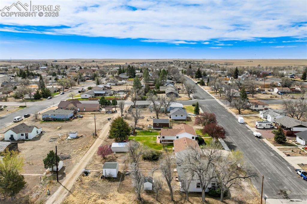 Image 34 of 37: View showcasing the home and established trees along 8th Street.