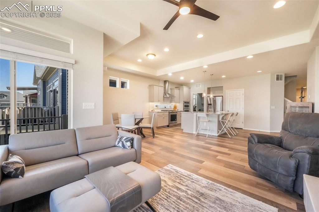 Image 20 of 50: Living room with mountain views, large fireplace, walk out access to deck
