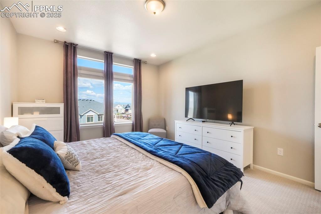 Image 24 of 50: Main level primary bedroom with ensuite and large walk in closet