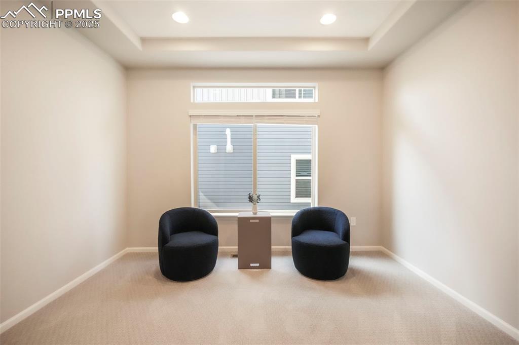 Image 8 of 50: Main level sitting room, office, formal dining, flex space with French door
