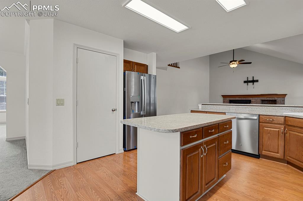 Image 10 of 50: This kitchen features a central island with a light-colored countertop and 