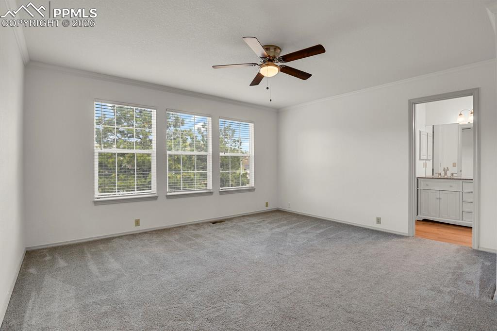 Image 23 of 50: This spacious room features light gray carpet, white walls, and a ceiling f