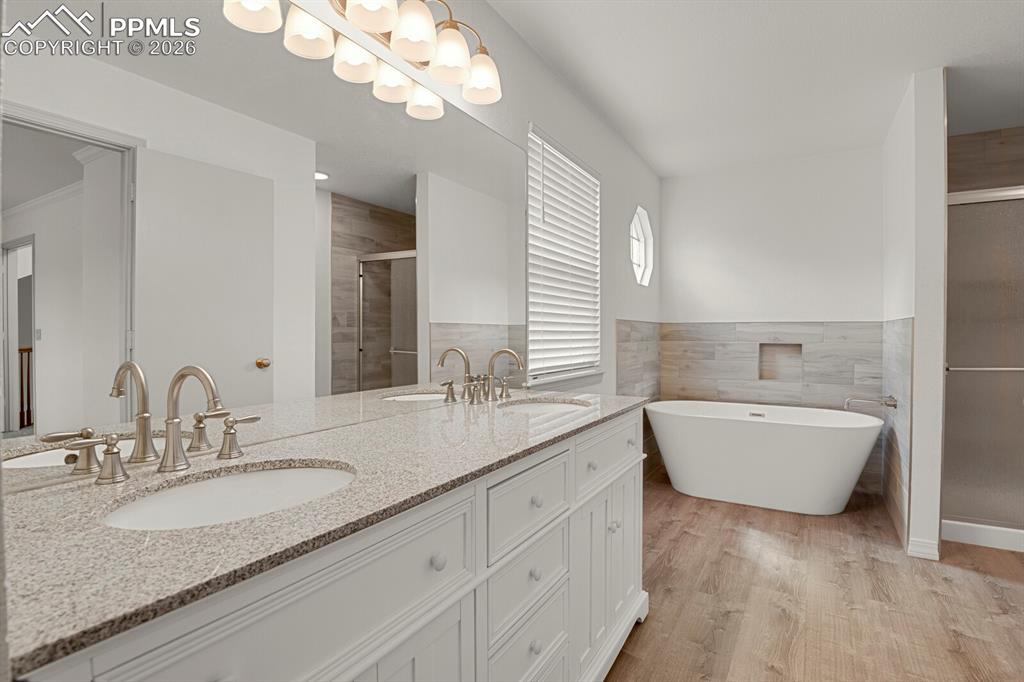 Image 26 of 50: The bathroom features a double vanity with light-colored granite countertop