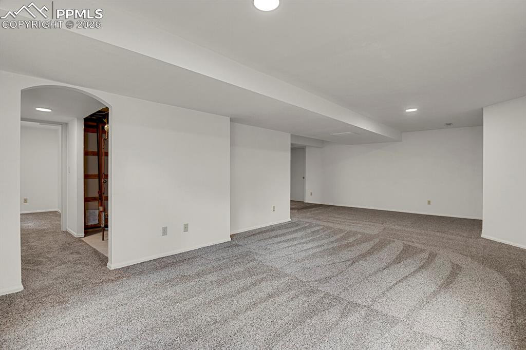 Image 36 of 50: Spacious room featuring light grey carpet, white walls, and recessed lighti