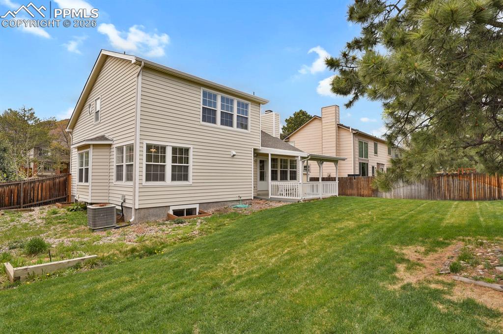 Image 44 of 50: The property features a spacious backyard with a well-maintained lawn and m