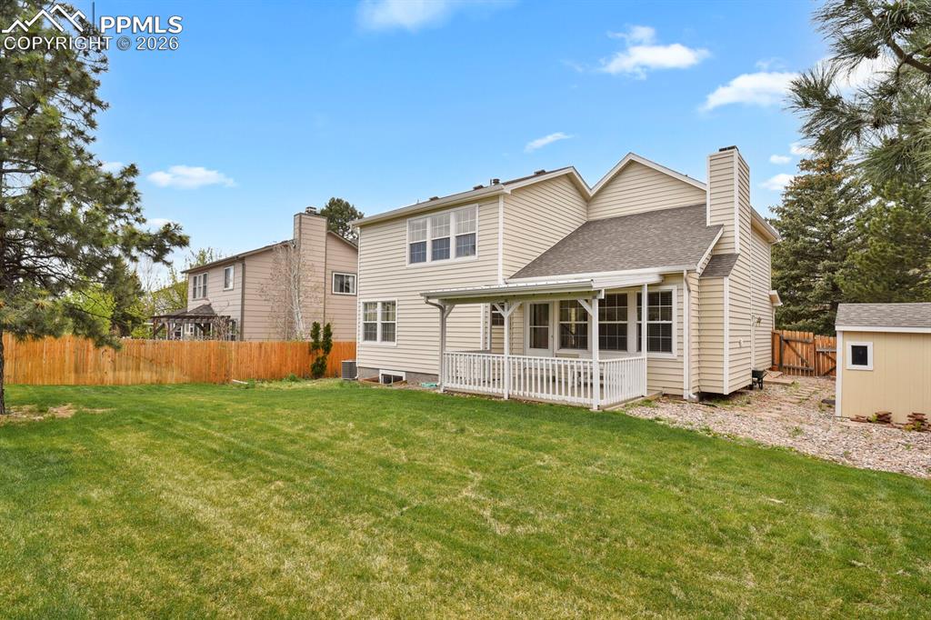 Image 45 of 50: The property features an extensive backyard with a well-maintained lawn, a 