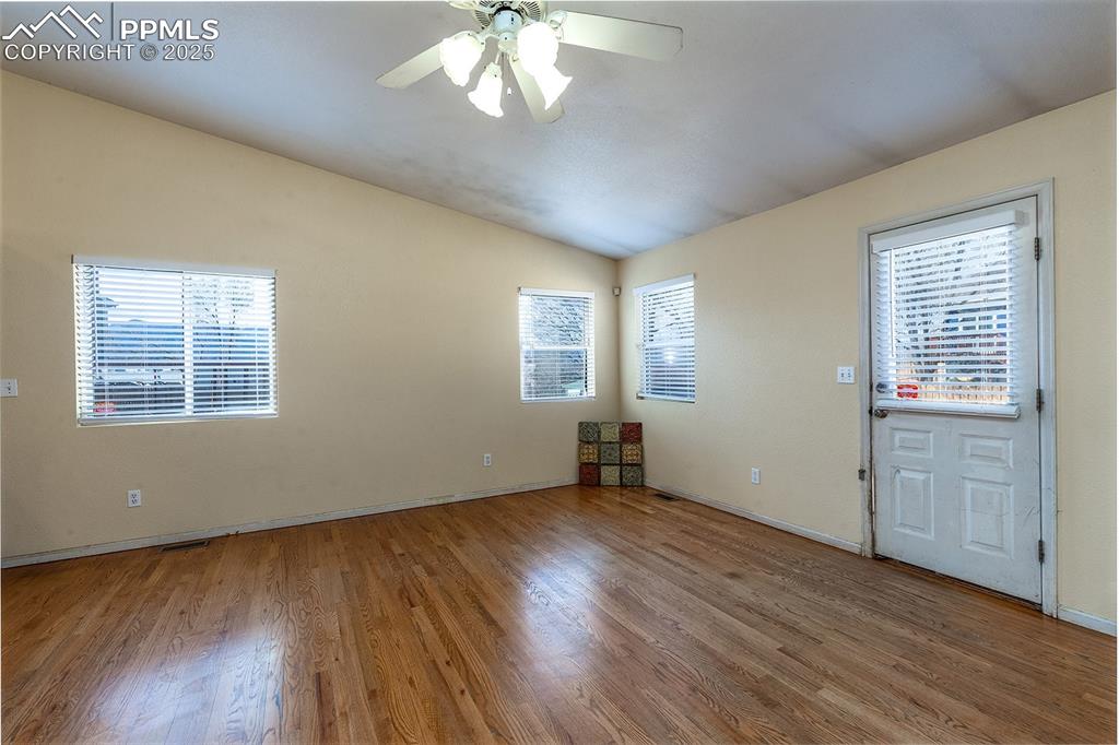 Image 11 of 31: Unfurnished room featuring a healthy amount of sunlight, wood finished floo