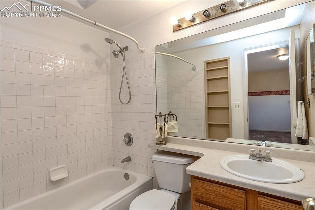 Image 15 of 31: Bathroom featuring toilet, shower / washtub combination, and vanity