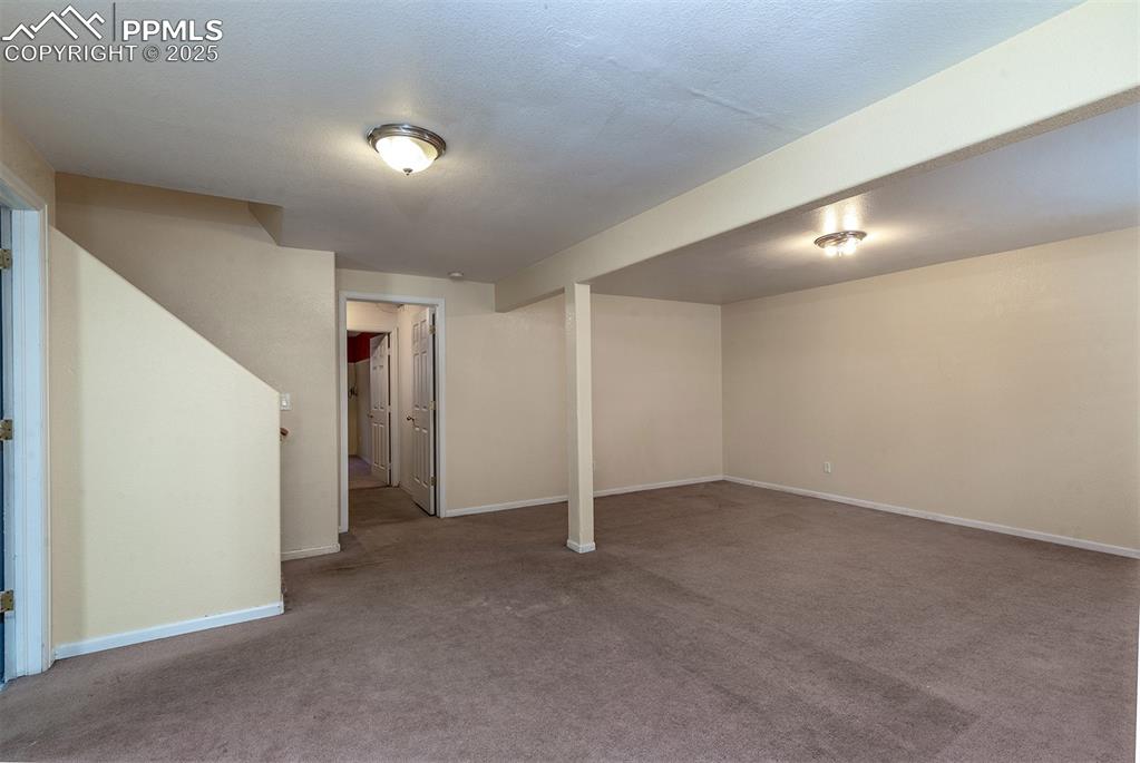 Image 19 of 31: Finished below grade area with carpet and baseboards