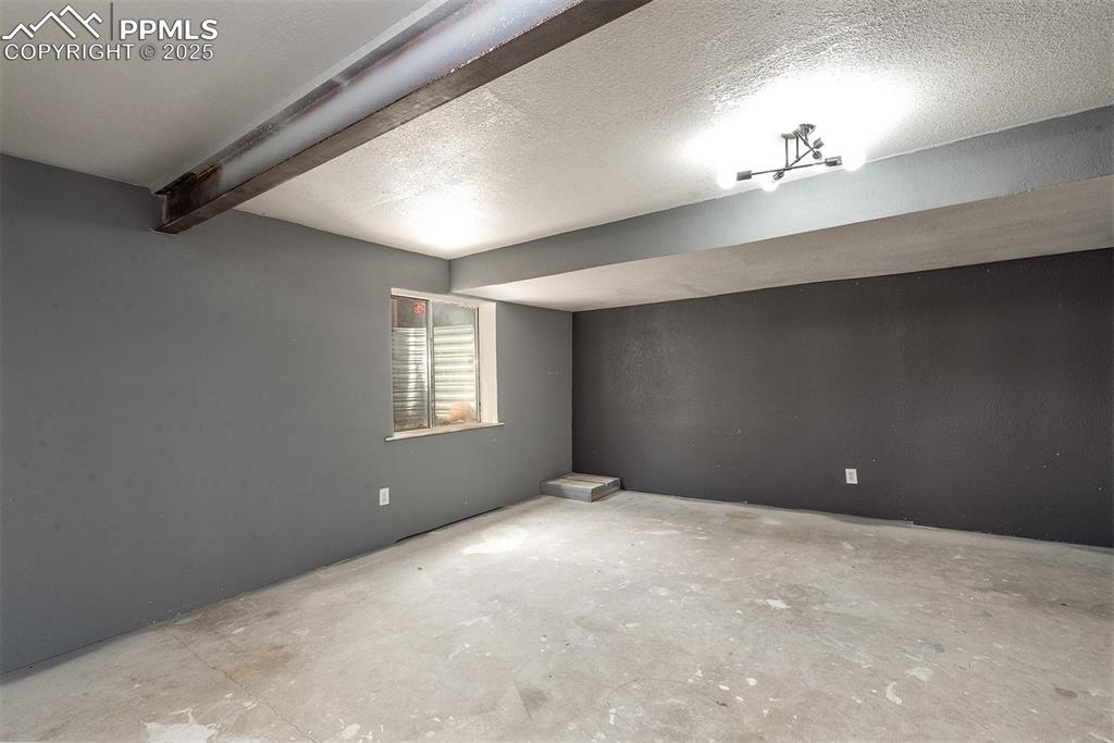 Image 24 of 31: Below grade area featuring a textured ceiling
