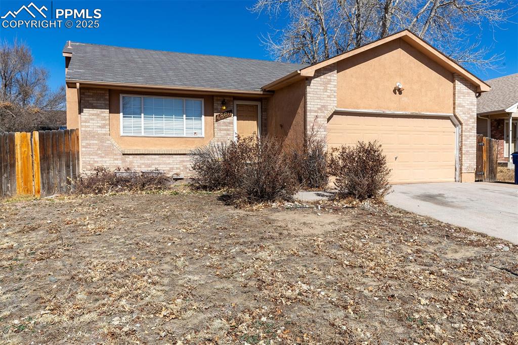 Image 30 of 31: Single story home with brick siding, a shingled roof, fence, concrete drive