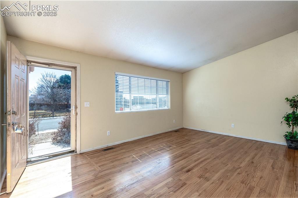 Image 5 of 31: Empty room with baseboards, visible vents, and light wood-type flooring