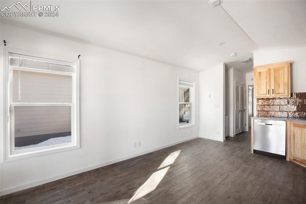 Image 4 of 15: Kitchen with backsplash, dark hardwood / wood-style flooring, light brown c