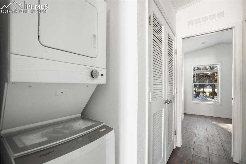 Image 8 of 15: Laundry area with stacked washer / dryer