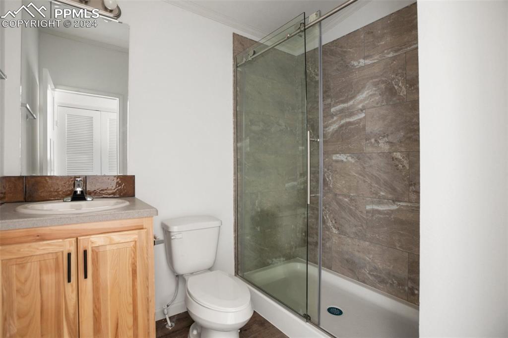 Image 9 of 15: Bathroom featuring enclosed shower and vanity