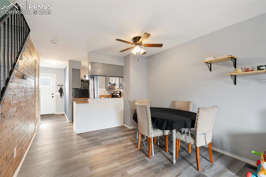 Image 15 of 28: Dining space with a ceiling fan and wood finished floors