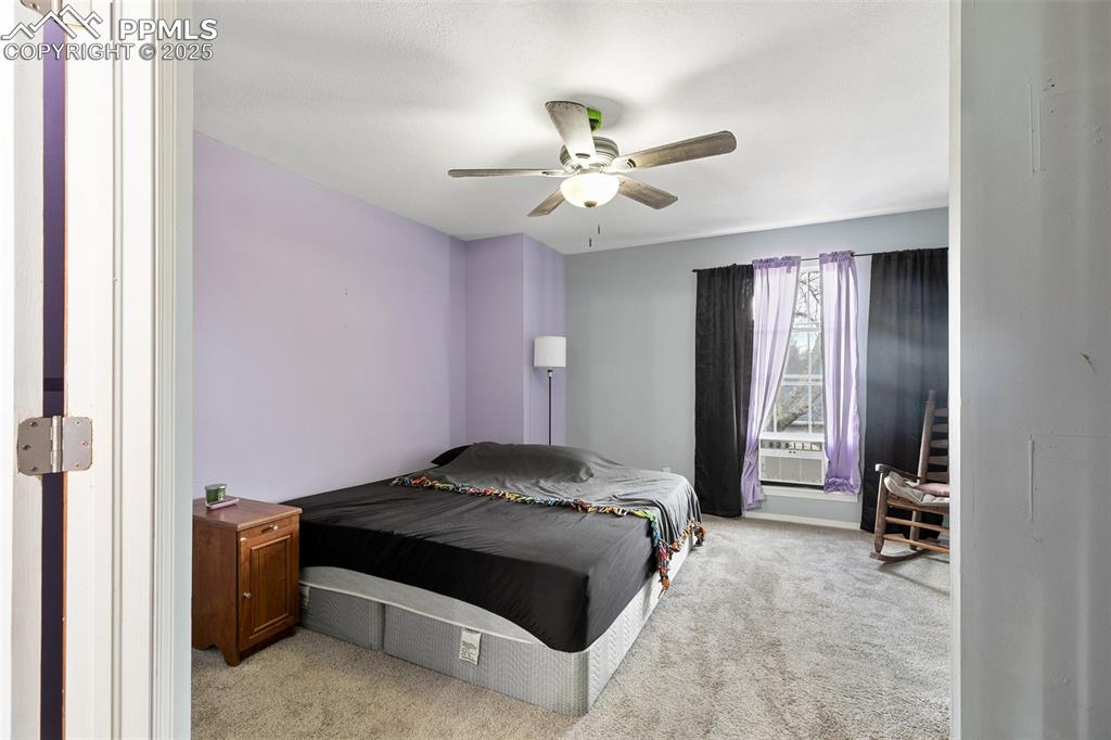 Image 17 of 28: Bedroom featuring light carpet and a ceiling fan