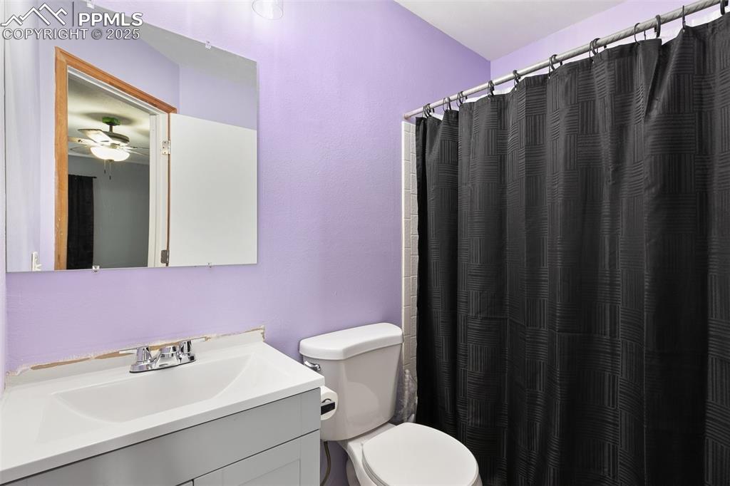 Image 19 of 28: Bathroom featuring vanity, a ceiling fan, and a shower with curtain