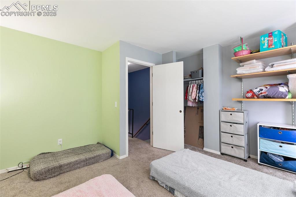 Image 21 of 28: Carpeted bedroom featuring baseboards and a closet