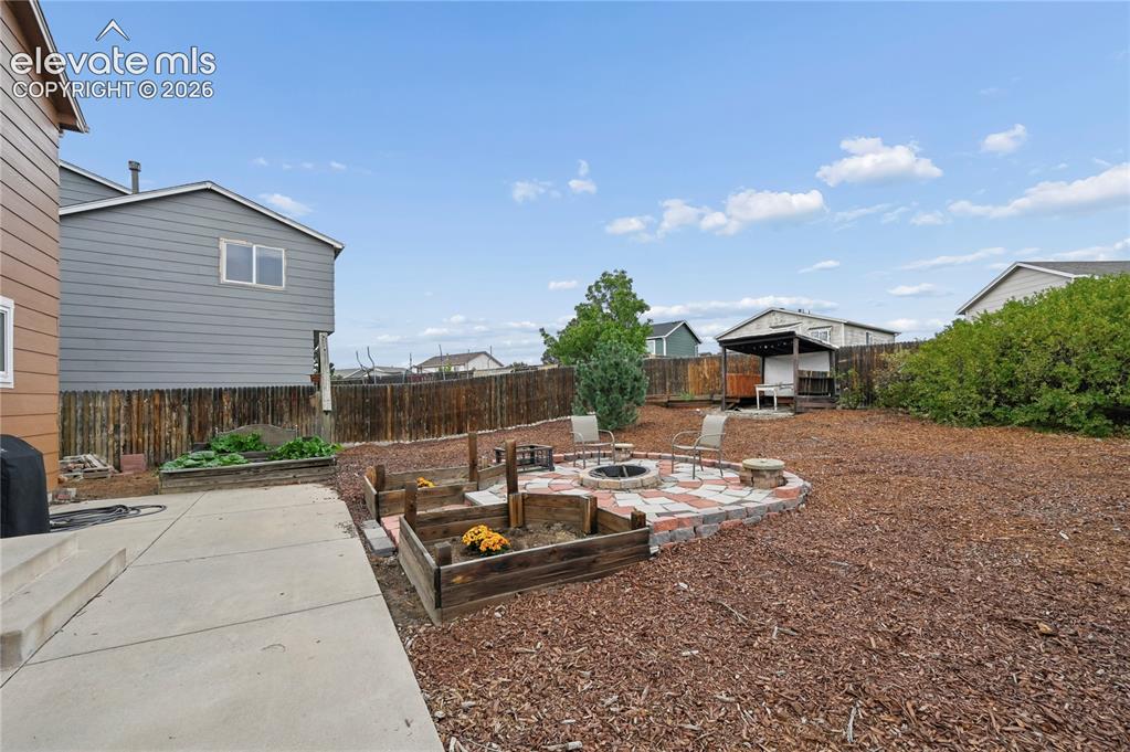 Image 11 of 41: Lots of patio space and a firepit area outside the dining room