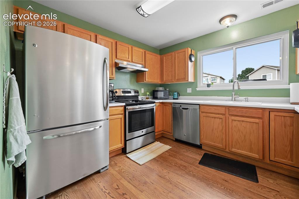 Image 16 of 41: Kitchen with stainless appliances