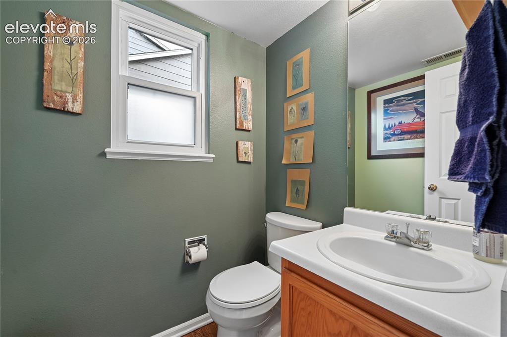 Image 17 of 41: Main level powder room in the back hallway