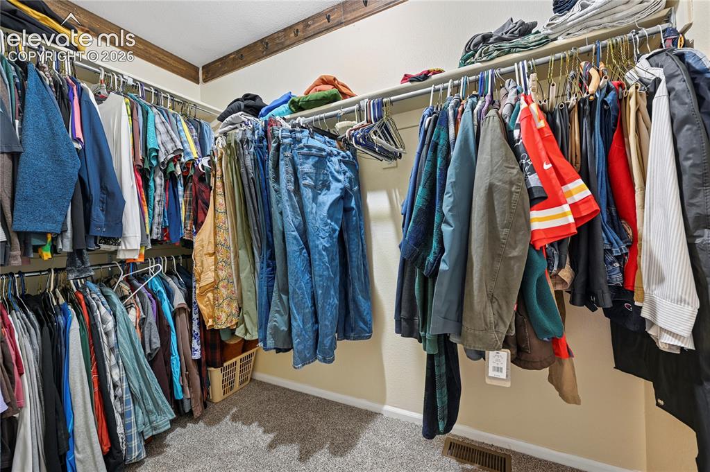 Image 22 of 41: Walk-in closet in the primary bedroom