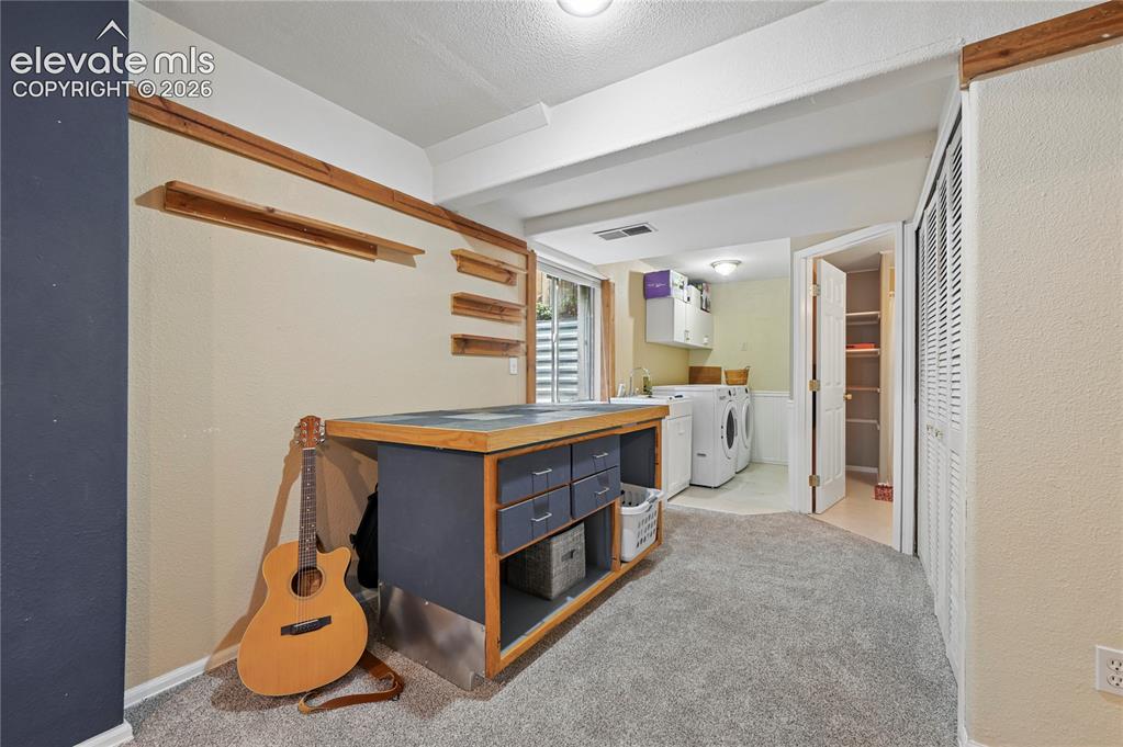 Image 33 of 41: Workbench or drafting desk in the large basement space