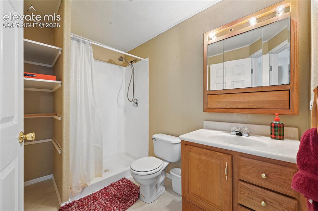 Image 34 of 41: Private 3/4 bathroom for the basement family room/ guest room/ play space.