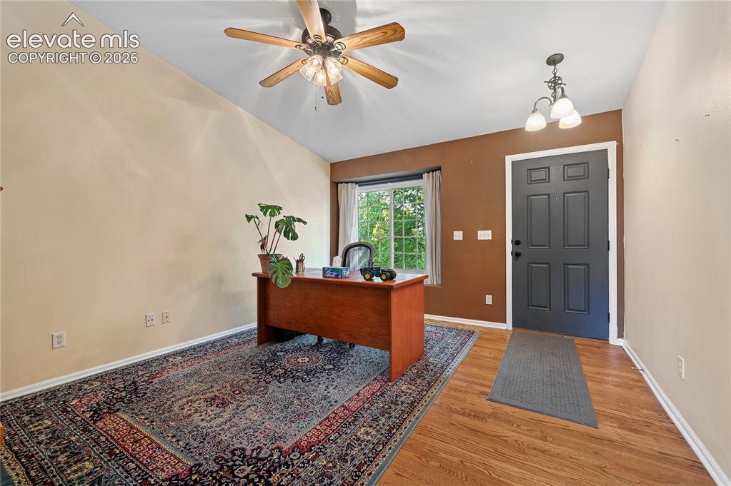 Image 4 of 41: Front room with solid-oak flooring for office or sitting room
