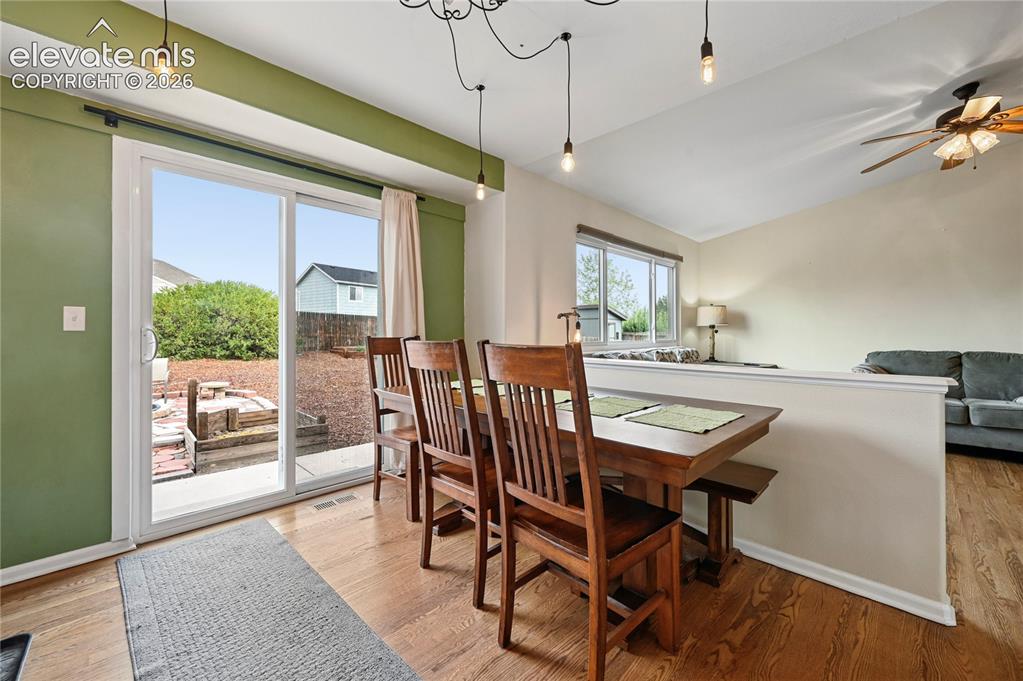 Image 8 of 41: Dining room in the middle of the main living areas with a full glass patio