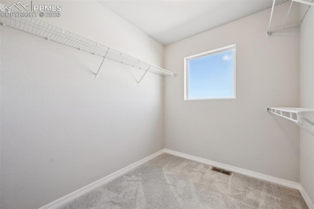 Image 23 of 38: walk in primary closet