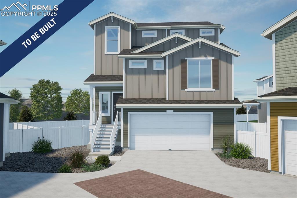 Caption: View of front facade with board and batten siding, an attached garage, fence, and decorative drivewa