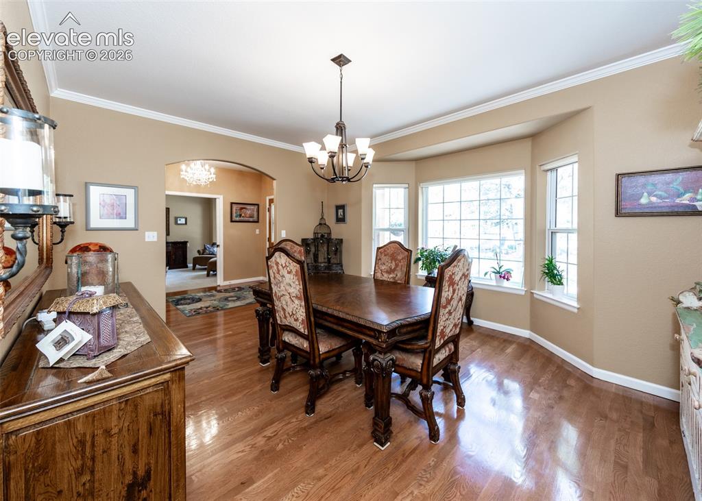 Image 16 of 50: Hardwood flooring throughout the dining area