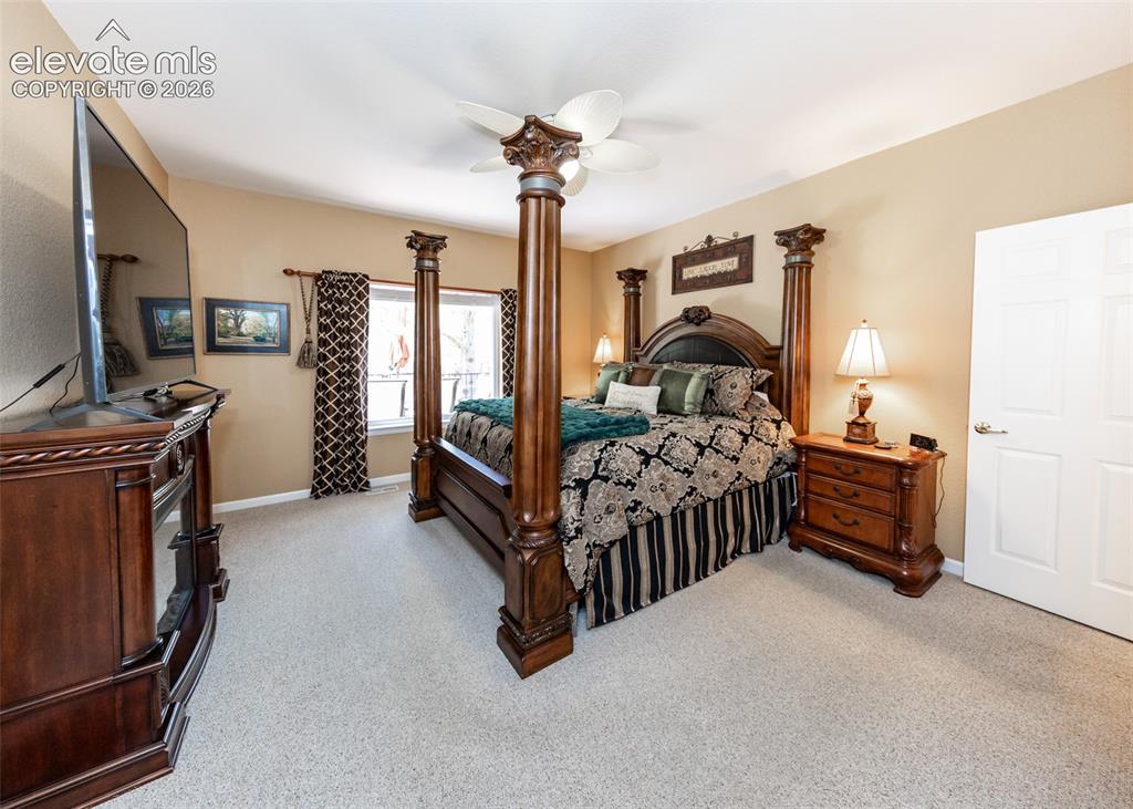 Image 23 of 50: Carpeted room featuring neutral-toned walls and a ceiling fan