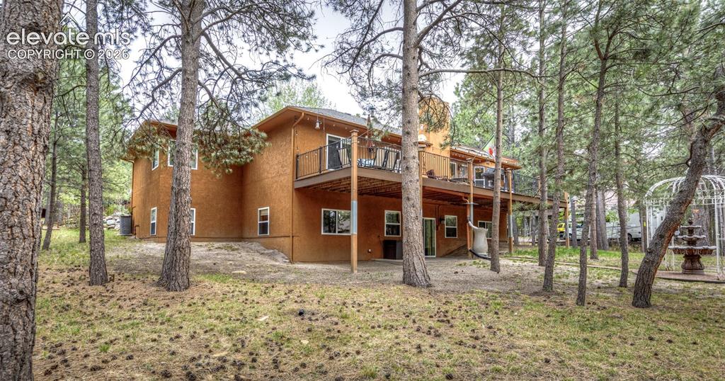 Image 50 of 50: Expansive exterior featuring a stucco finish, multi-level deck with black r