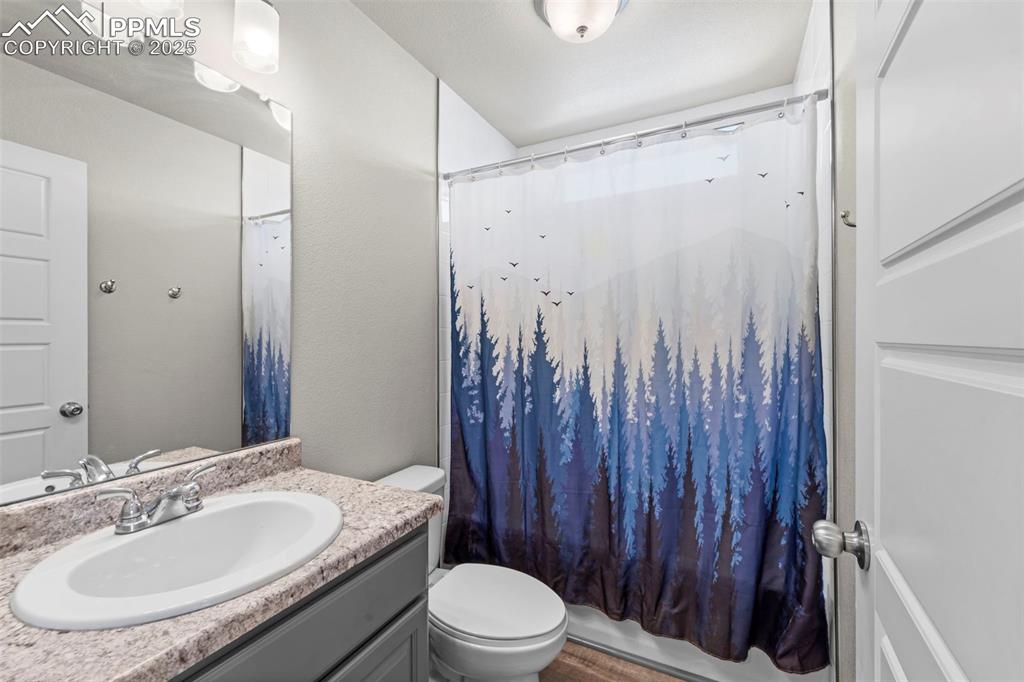 Image 20 of 30: Full bath featuring vanity and shower / bath combo with shower curtain